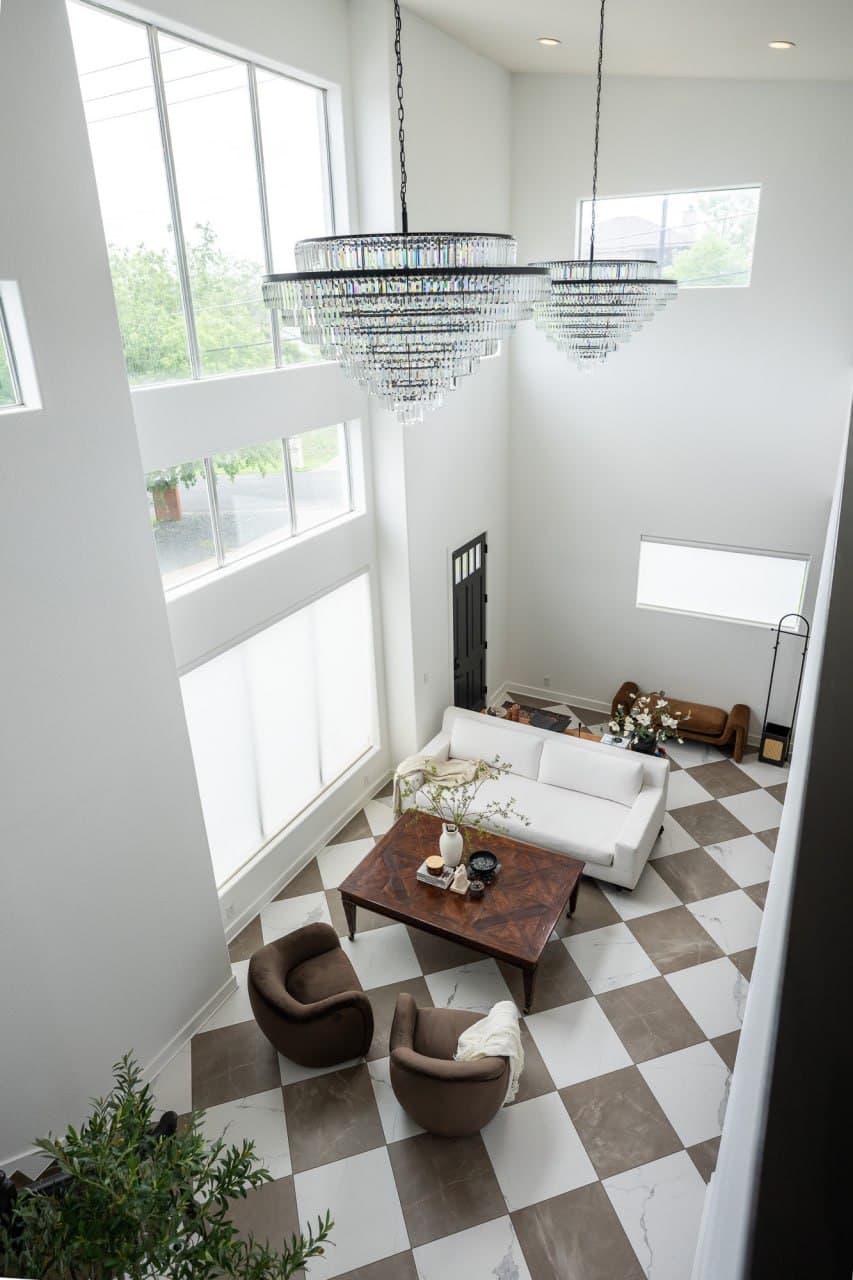 Vue Studio Austin interior — crystal chandeliers and living room set